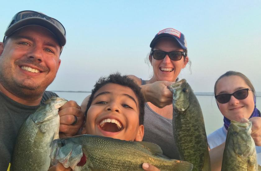 family fishing for bass, all smiles