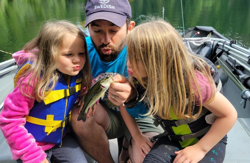 Dad fishing on Langlois Lake with his two daughters