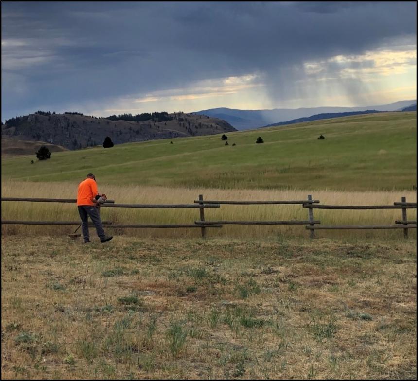 Peterson maintaining a fence on Silver Hill