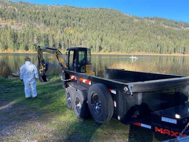 Palmer with mini-excavator and dump trailer. 