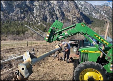 Rise and a tractor removing a gear box from the pivot frame.