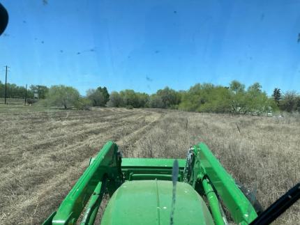 A tractor mowing grass.