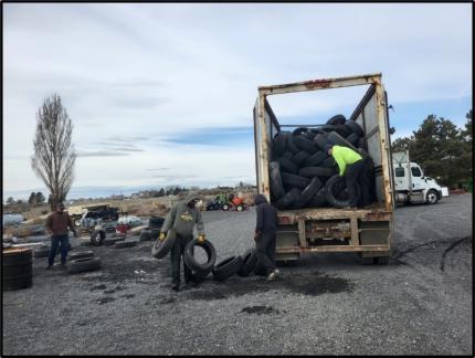 Wildlife area staff members and contractors loading tires.