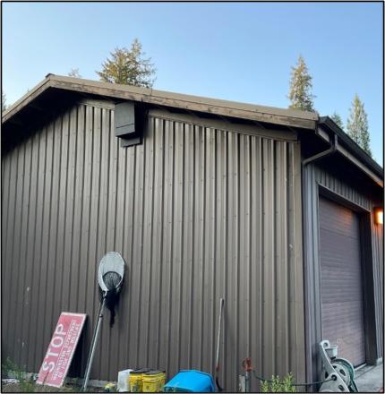 A bat house on the side of a building.