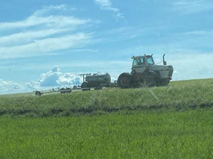 A tractor spraying the fields