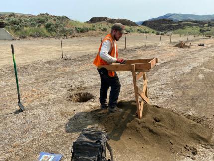 A cultural resource contractor sifting soil