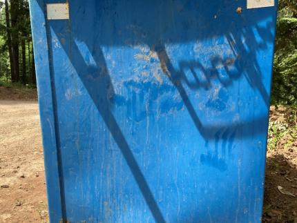 The side of a dumpster with bear paw prints