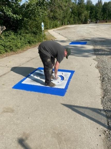 Brant repainting ADA parking spaces.