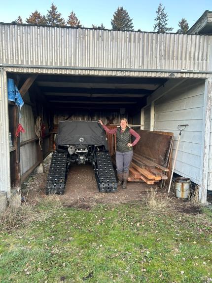 Biologist Butler showing off the new enclosed area for storage of the District 11 tracked ATV.  