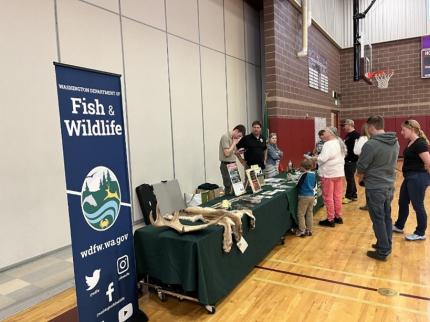 Staff members hosting a table at the Medical Lake Middle School Career Night. 