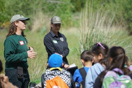 Staff members talking with Eastmont Elementary students.