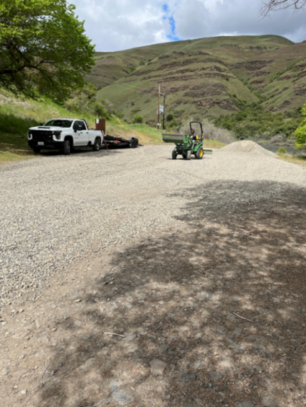 Person spreading gravel at Boggan’s Access Site. 