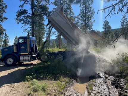 Angular rock being dumped into mudholes, Colockum Wildlife Area.