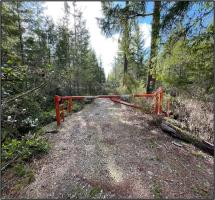 A cleared road with a gate