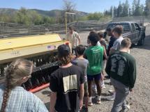 Gaston demonstrating a no-till drill equipment for students.